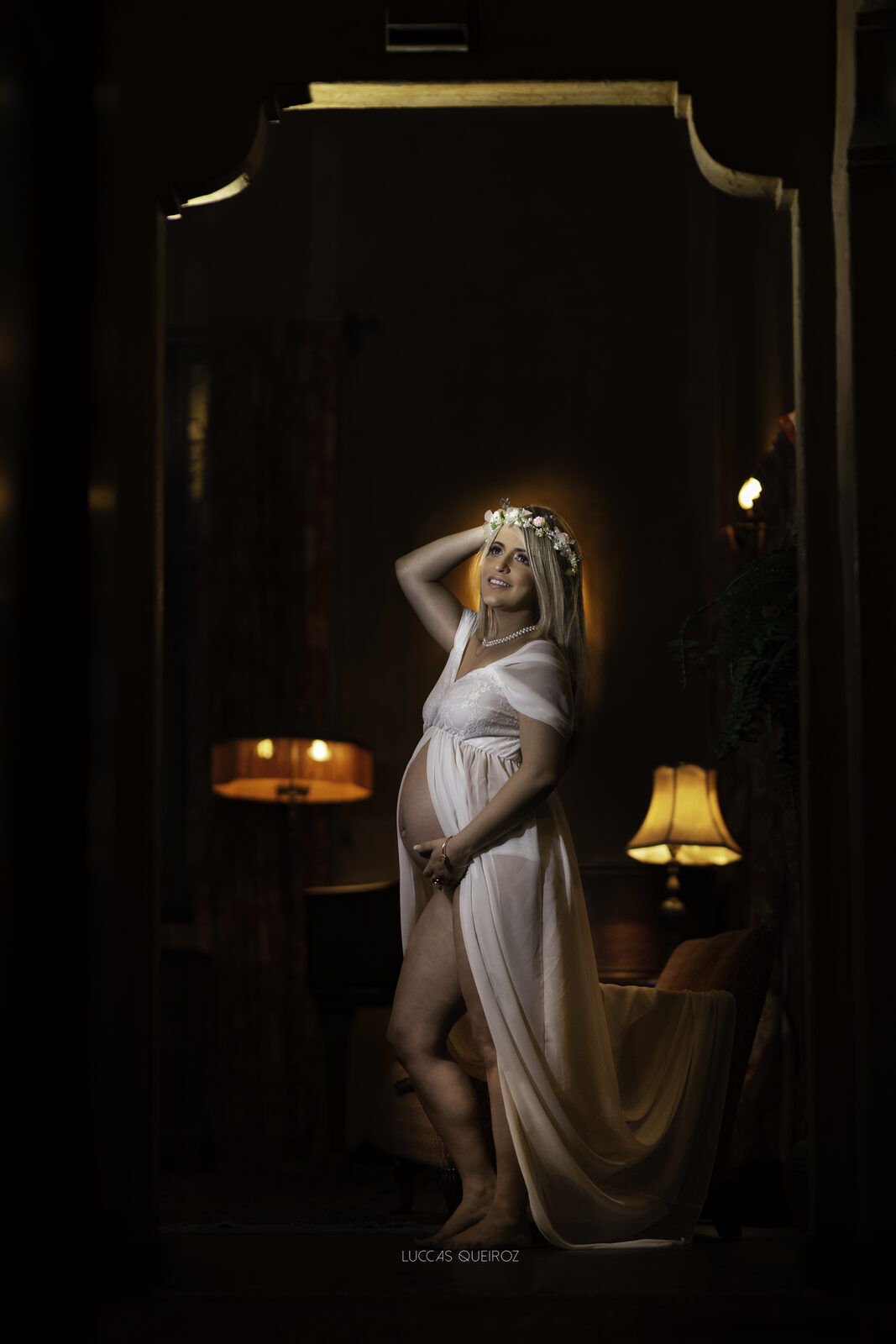 Maternity portrait in warm lamplight