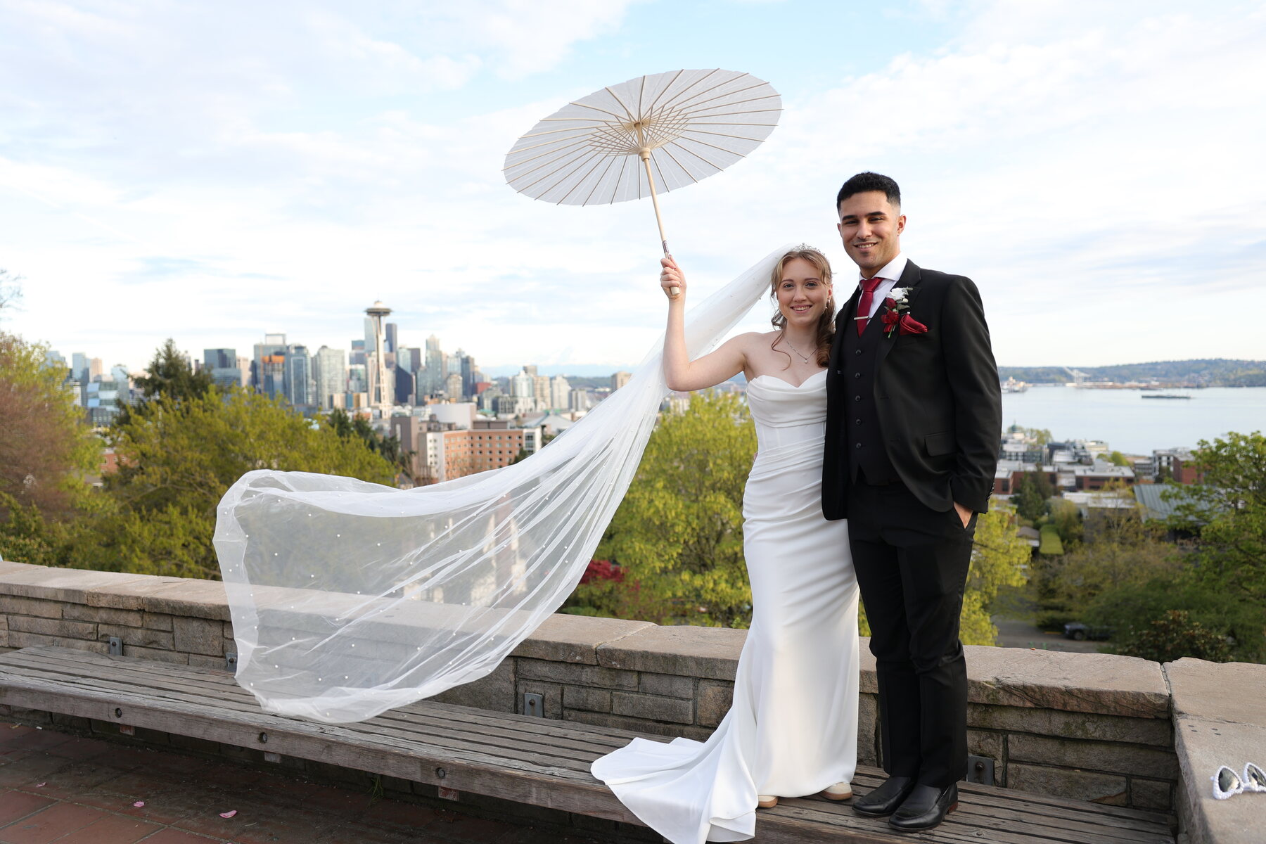 Bride and groom above the Seattle skyline